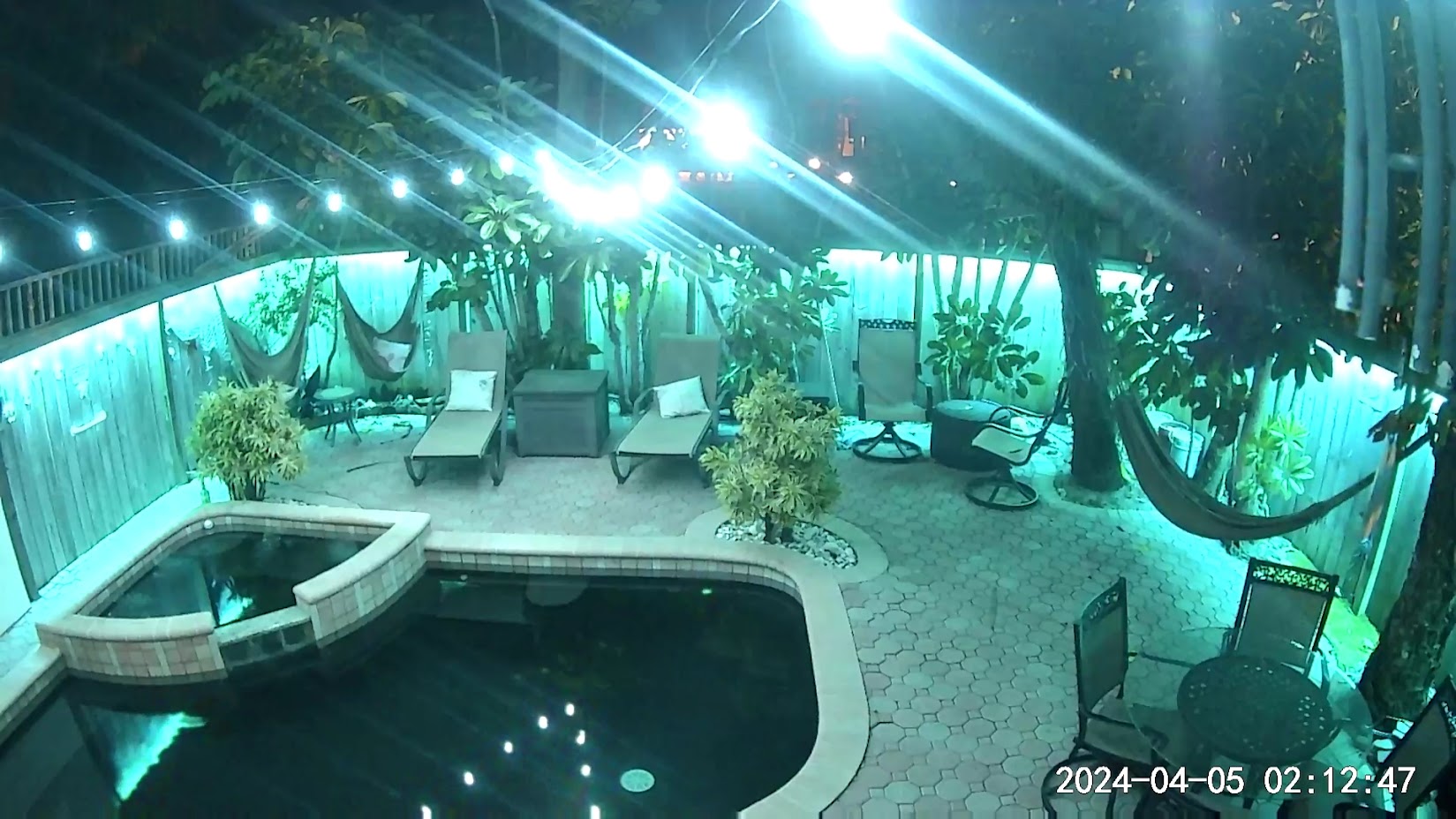 Nighttime pool and patio camera coverage from a Cocoa Beach townhome